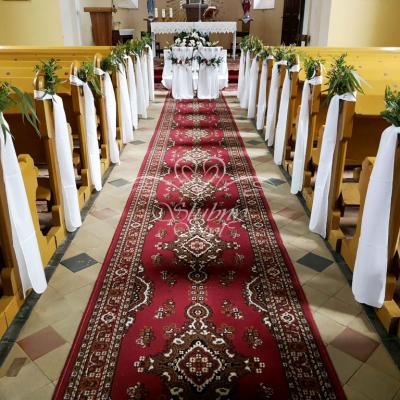 Dekoracja ławek zielenią i białą wstążką