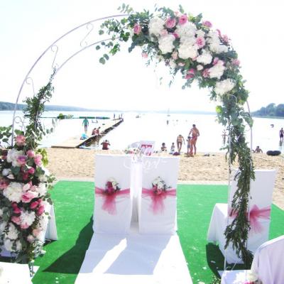 Łuk ślubny bogato zdobiony świeżymi kwiatami